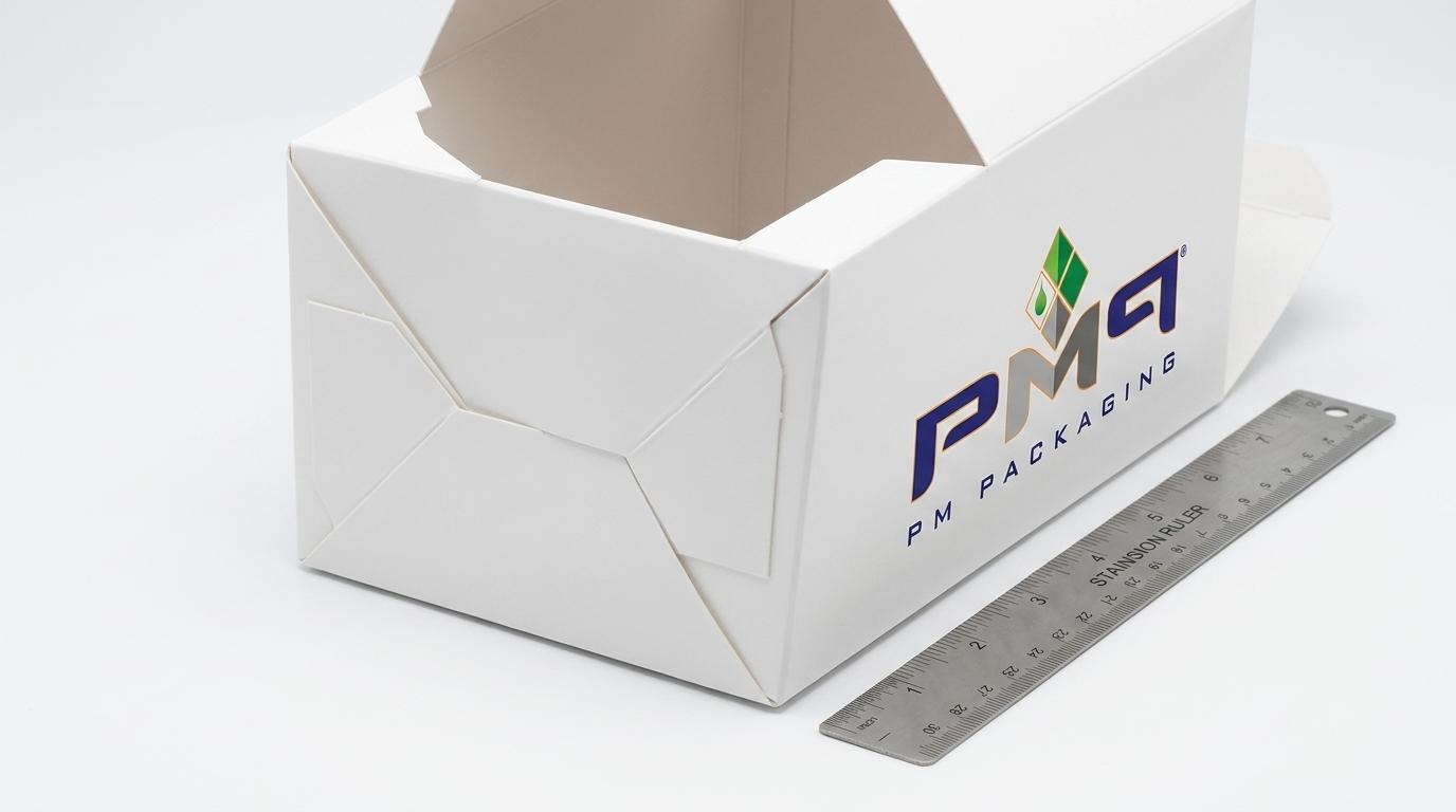 Auto-bottom crash-lock carton showing pre-glued diagonal fold geometry and automatic interlocking base action by PM Packaging